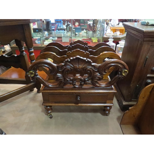 218 - A 19th Century rosewood three division Canterbury with carved decoration over a single base drawer o... 