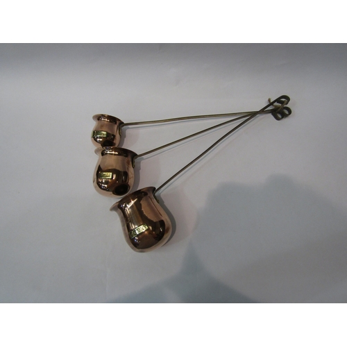 281 - A set of three copper and brass brandy, rum and whisky toddy ladles