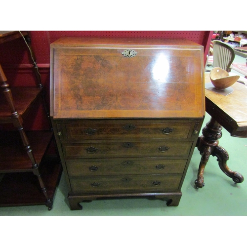 63 - A burr walnut bureau, the well fitted interior over four graduating long drawers on bracket feet wit... 