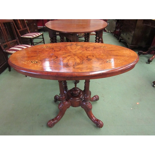 73 - A Victorian walnut oval top occasional/centre table with four pillar support over quatreform base. 6... 