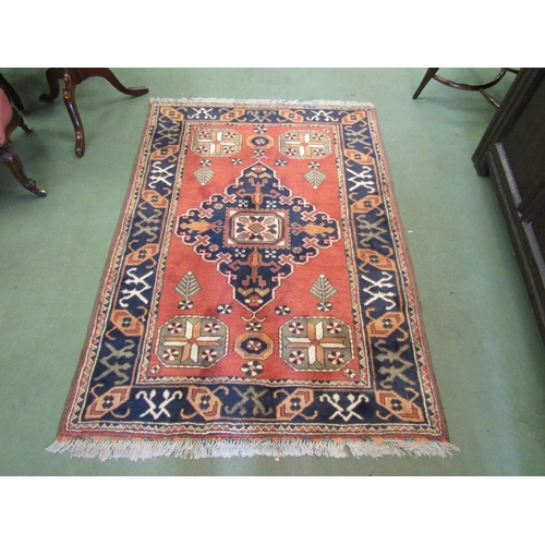 74 - A modern handwoven rug, central diamond detail, multiple border, 107cm x 152cm