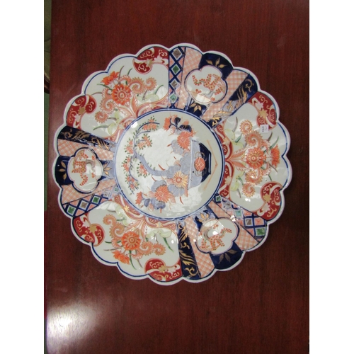 78 - An Oriental scallop edged charger in the Imari palette, 37cm diameter