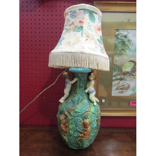 62 - A Majolica style table lamp with pair of cherubs climbing, a/f   (E) £8-12