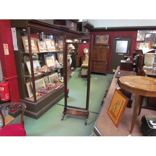 183 - An Edwardian oak cheval mirror with reeded frame the turned finials over a shelf base and sledge fee... 