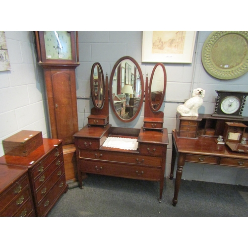 1050 - An Edwardian mahogany dressing table with triple oval mirrors. 170cm x 111cm x 50cm