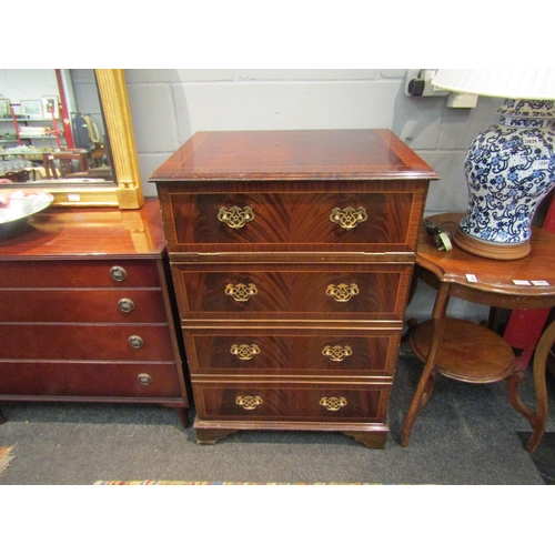 1064 - A mid 20th Century reproduction mahogany pseudo straight front chest of four long drawers, disguisin... 