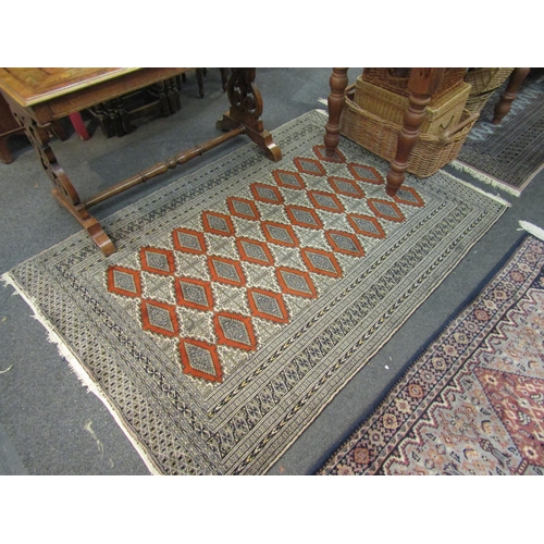 1082 - A Middle Eastern geometric rug with three rows of central gulls, 184cm x 127cm