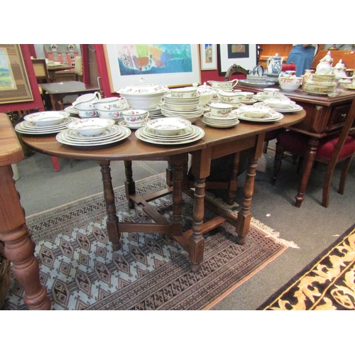 1097 - A 20th Century oak gateleg dining table, with D-shaped drop leaves   (D)