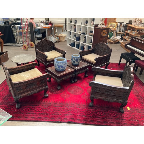 1129 - An early 20th Century Chinese rosewood lounge suite consisting of four heavily carved armchairs toge... 