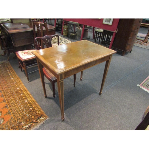 1144 - An Edwardian mixed wood rectangular occasional table, raised on tapering square section legs to spad... 