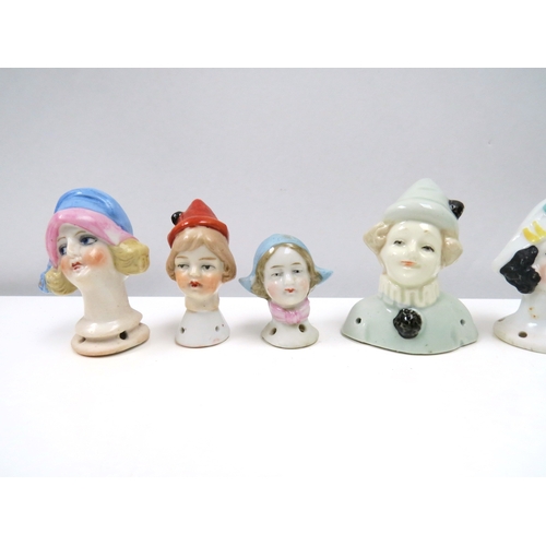 1281 - Eight glazed china heads including Pierrette