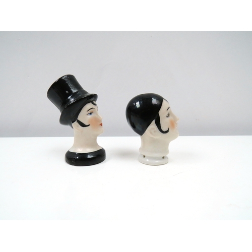 1315 - Two porcelain female cushion heads, lady wearing top hat and pierrette 6cm & 5cm tall   (R) £20