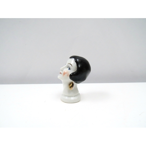 1315 - Two porcelain female cushion heads, lady wearing top hat and pierrette 6cm & 5cm tall   (R) £20