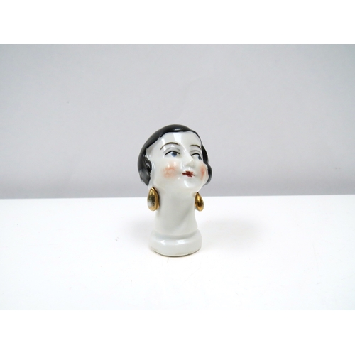 1315 - Two porcelain female cushion heads, lady wearing top hat and pierrette 6cm & 5cm tall   (R) £20