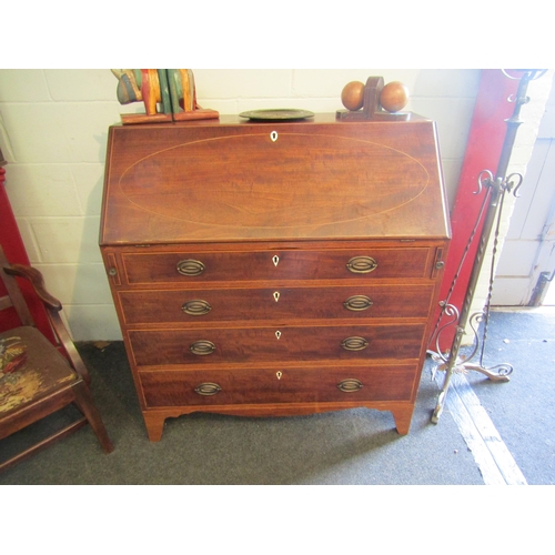 1005 - A George III mahogany bureau with four graduating maple drawers and pigeon hole interior, green baiz... 