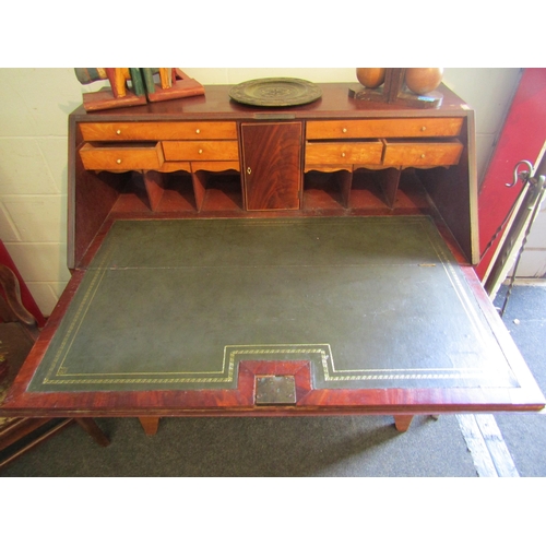 1005 - A George III mahogany bureau with four graduating maple drawers and pigeon hole interior, green baiz... 