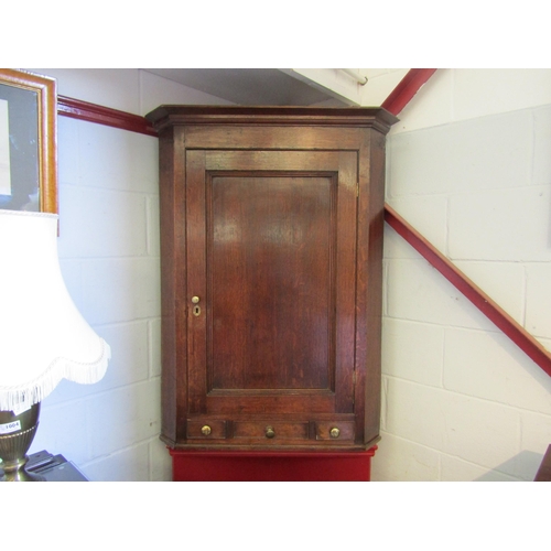 1006 - A Georgian oak corner cupboard with three drawers. 114cm high x 86cm wide