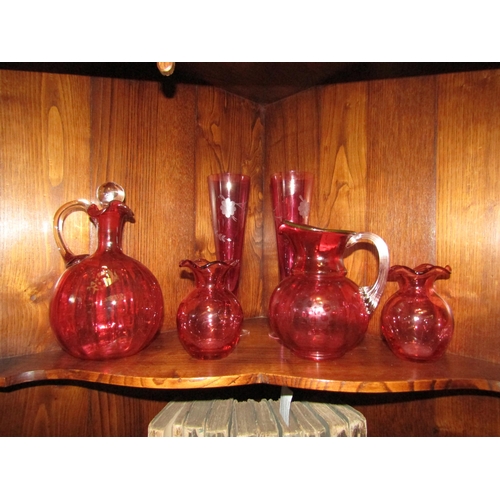 1051 - A selection of Victorian and later cranberry glass including decanter, jugs and glasses