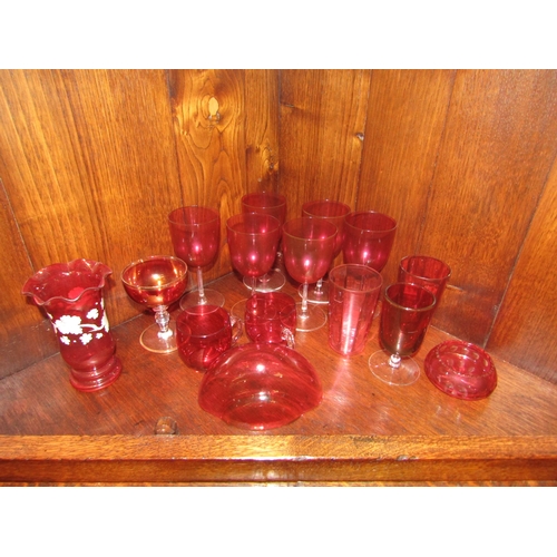 1051 - A selection of Victorian and later cranberry glass including decanter, jugs and glasses