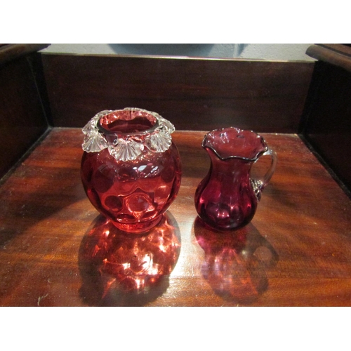 1051 - A selection of Victorian and later cranberry glass including decanter, jugs and glasses