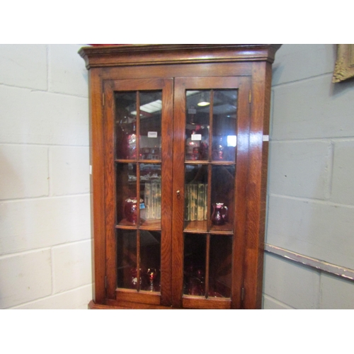 1053 - A modern oak glazed corner cabinet with bottom field panel doors. 199cm high x 84cm wide   (R) £50