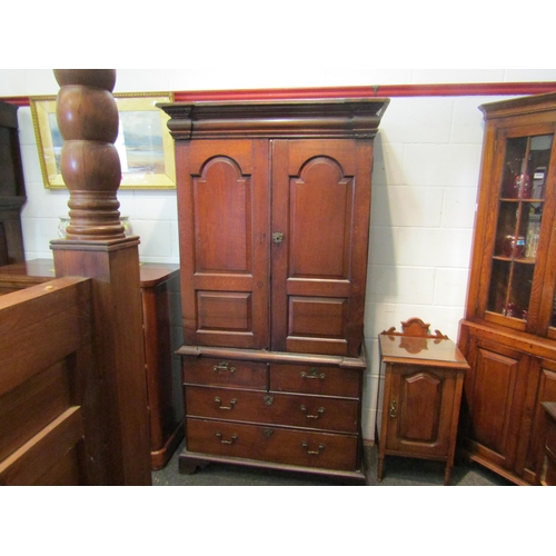 1057 - An early to mid 18th Century oak slim two door cupboard over two over two drawer base with swan neck... 