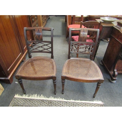 1084 - A pair of Regency reeded back chairs with cane seats, satinwood line inlay