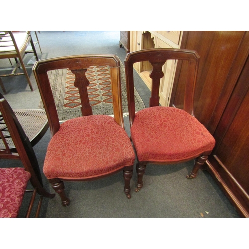 1088 - A pair of Victorian curved back single chairs with turned front legs to castors