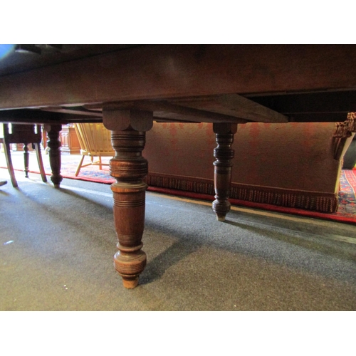 1139 - A late 19th/early 20th Century oak extending dining table with four extra leaves. Approx. 12ft long