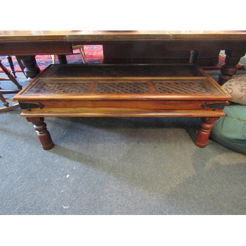 1140 - An Eastern hardwood coffee table with glass top of lattice weave panels   (E) £15-20