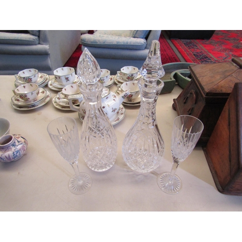 1162 - Two crystal glass decanters and a pair of champagne flutes (4)