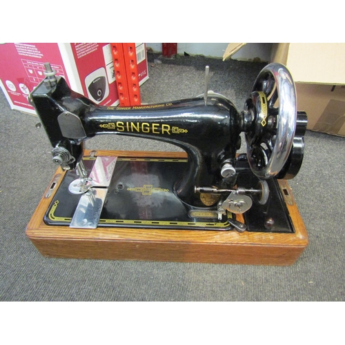 1213 - An oak cased Singer sewing machine