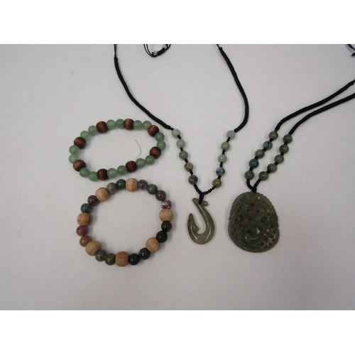 1269 - A carved jade dragon pendant, two bracelets and a necklace