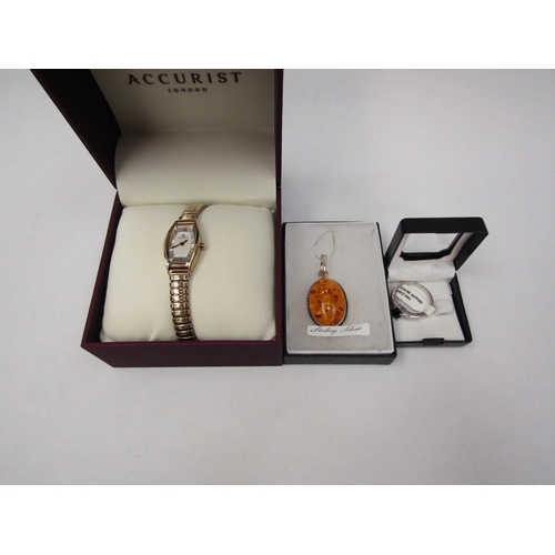 1287 - An amber pendant on chain, a sapphire set ring and an Accurist wristwatch