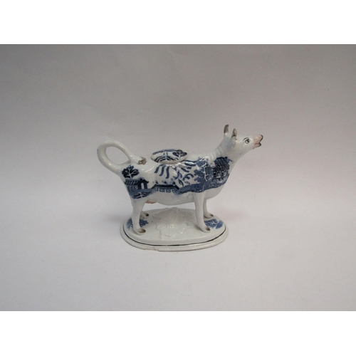 1323 - An early 19th Century creamer, blue and white pagoda Chinese pattern, painted face, possibly Staffor... 