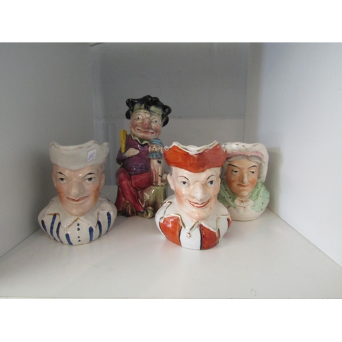 1353 - A Melba Ware Toby jug depicting Mr Punch and dog and three similar character jugs, unmarked (4)