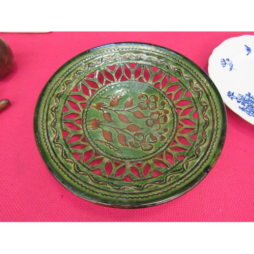 1466 - A green glazed studio pottery dish with cut out border and flower decoration, 30cm diameter   (R)  £... 