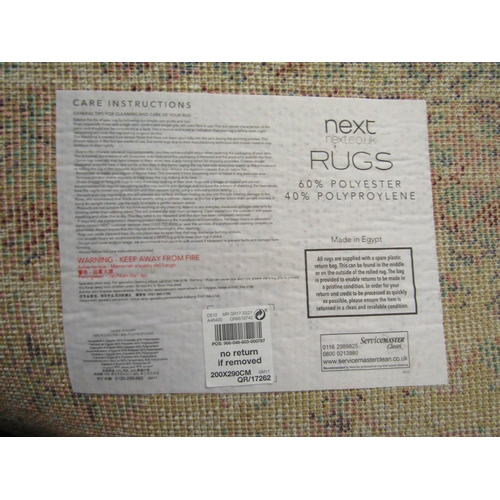 1488 - A Next polyester and polypropylene cream ground rug, 290cm x 200cm