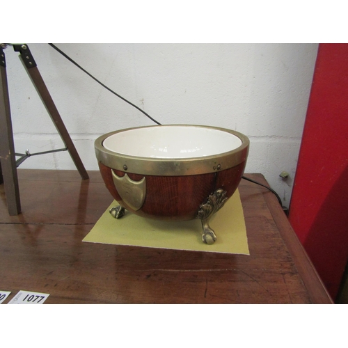 1075 - A 19th Century oak metal bound bowl raised on ball and claw feet with ceramic liner, engraved shield... 