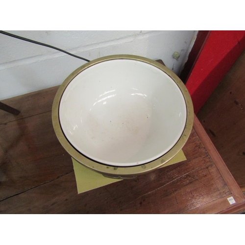 1075 - A 19th Century oak metal bound bowl raised on ball and claw feet with ceramic liner, engraved shield... 