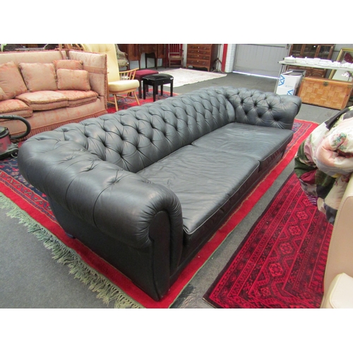 1148 - A large black leather Chesterfield sofa   (R) £80