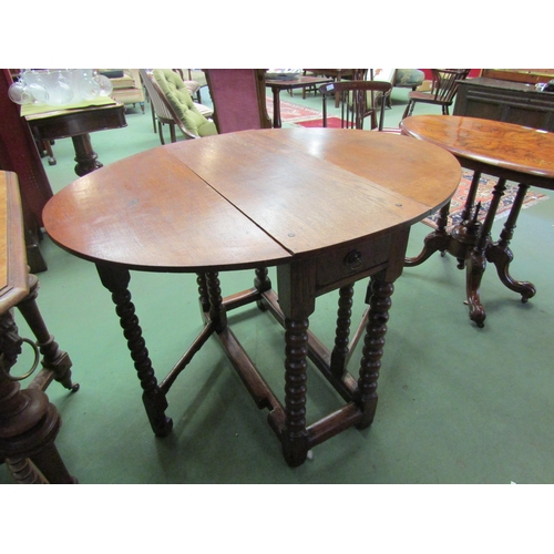 4056 - An 18th Century pegged oak gateleg table the rising leaves oval top and cutlery end drawer over bobb... 