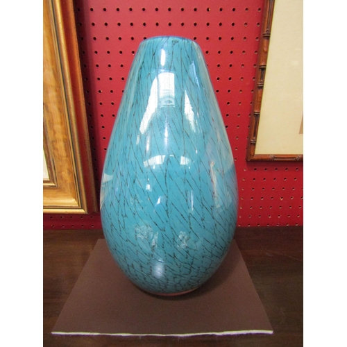 4027 - A turquoise blue glass vase with black line detail, 28cm high