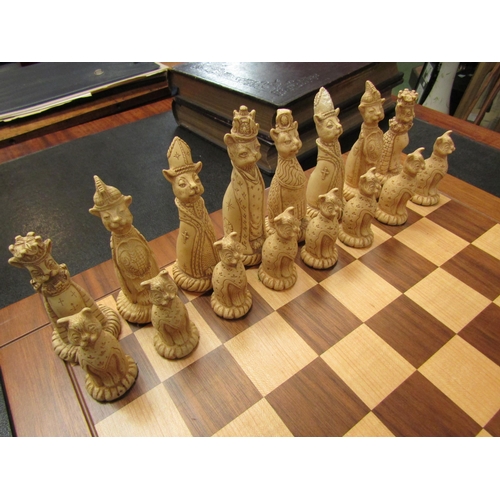 4100 - A Tudor rose chessboard and another chess set with Cheshire cat themed pieces