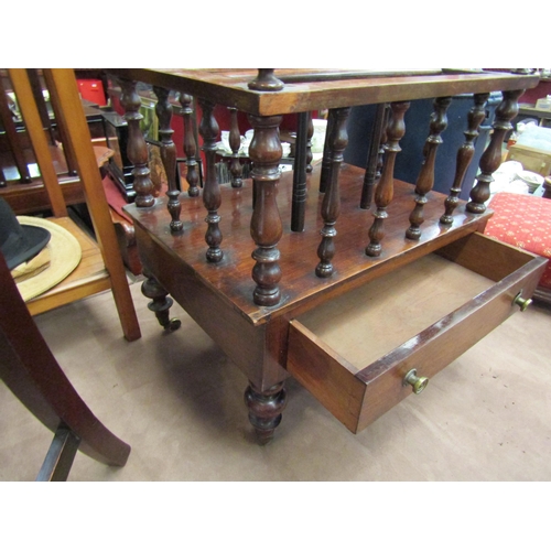 4207 - A mahogany Canterbury on castors with turned supports and drawers, 53cm tall