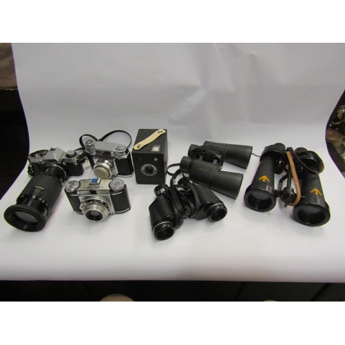 4401 - A quantity of cameras and binoculars incl Olympus OM20 SLR camera and Barr and Stroud CF41 naval bin... 