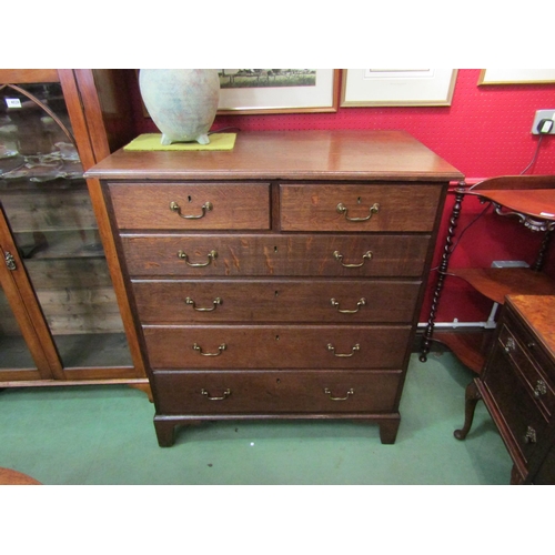 4033 - Circa 1780 a George III oak country chest of two short over four graduating long drawers with brass ... 