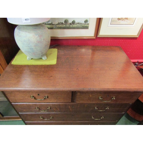 4033 - Circa 1780 a George III oak country chest of two short over four graduating long drawers with brass ... 