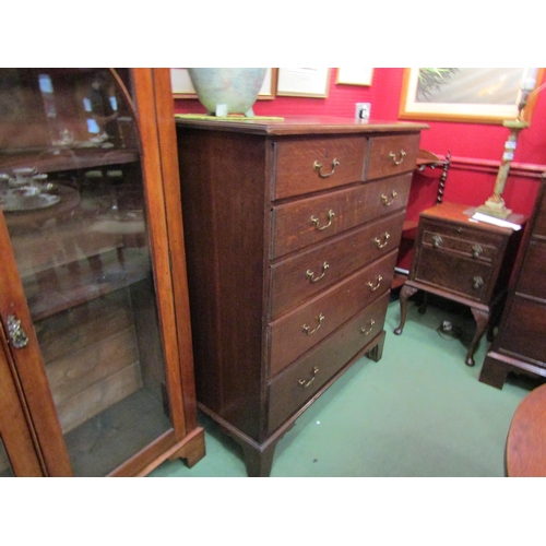 4033 - Circa 1780 a George III oak country chest of two short over four graduating long drawers with brass ... 