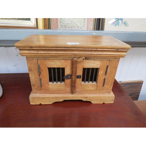 2062 - A small Eastern harwood two door table cupboard with metal barred details to doors